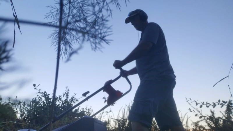 Me mowing a lawn at dusk