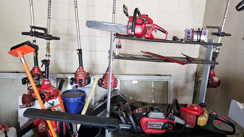 Petrol and battery gear on the workshop shelf