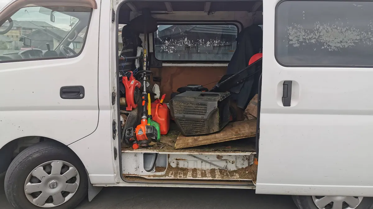 Work van with the side door open and the gear loaded