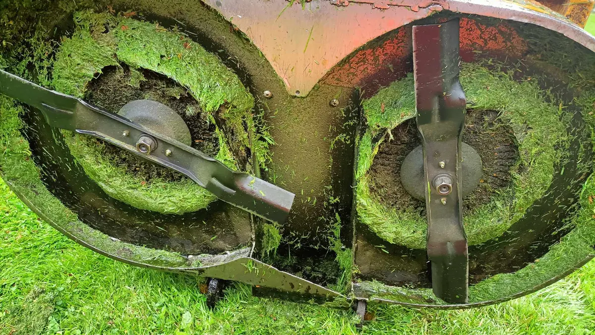 Grass clippings caked under a mower deck