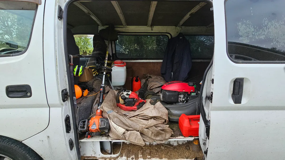 Van loaded with mowers, trimmers and fuel