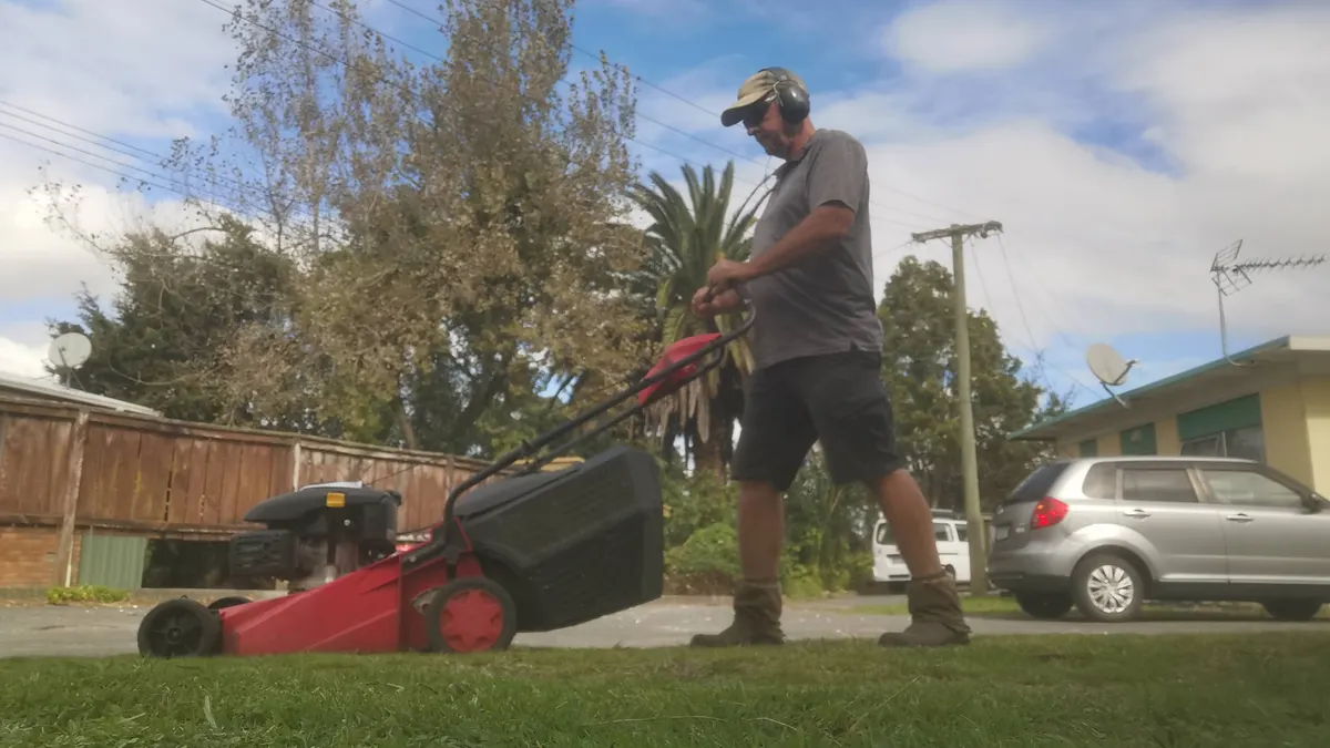 Mowing a front lawn on a sunny day