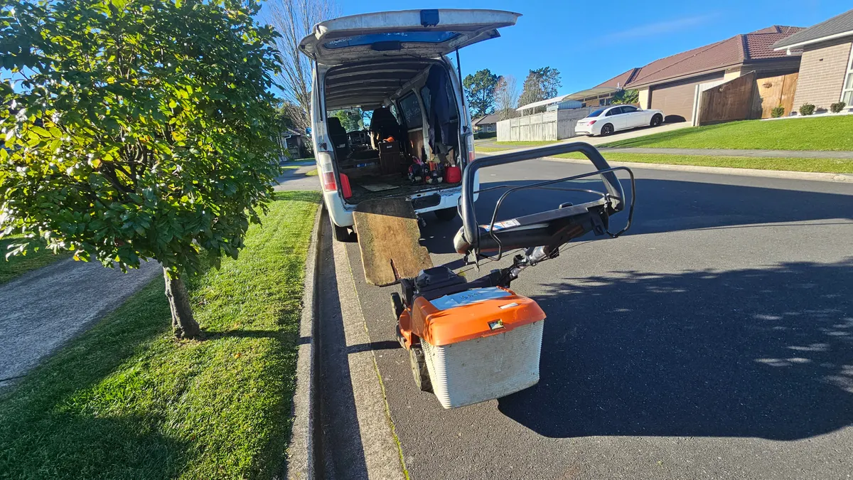 Loading the mower back into the van between jobs