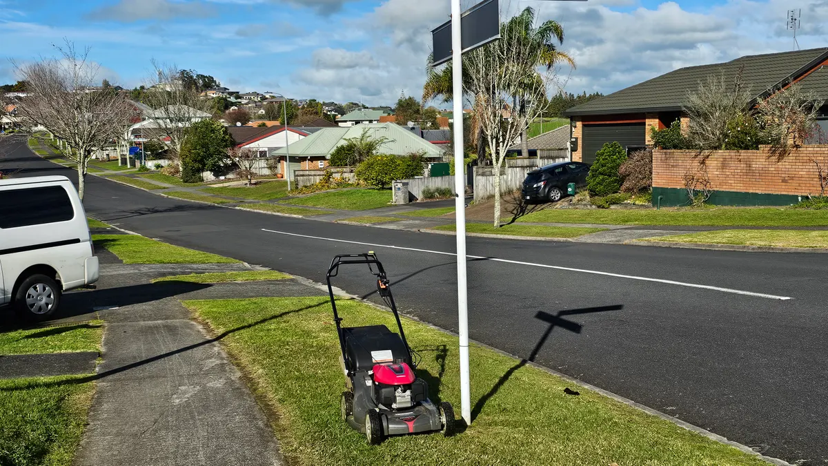 Mower on a street-front lawn