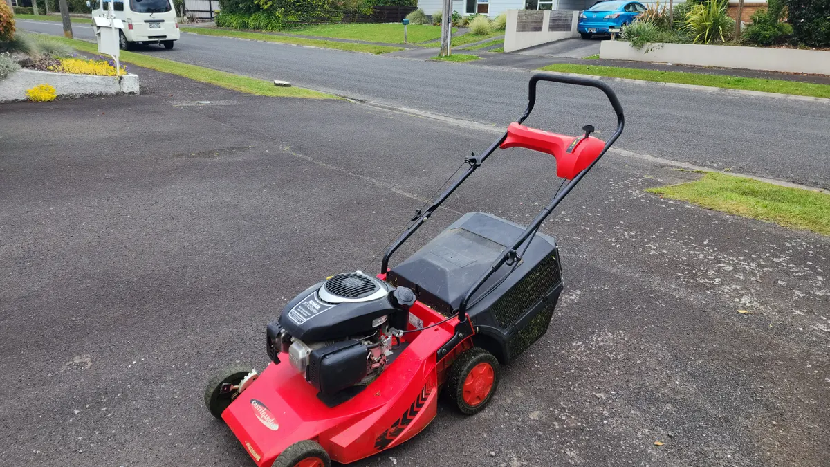 Red mower on the berm by the road