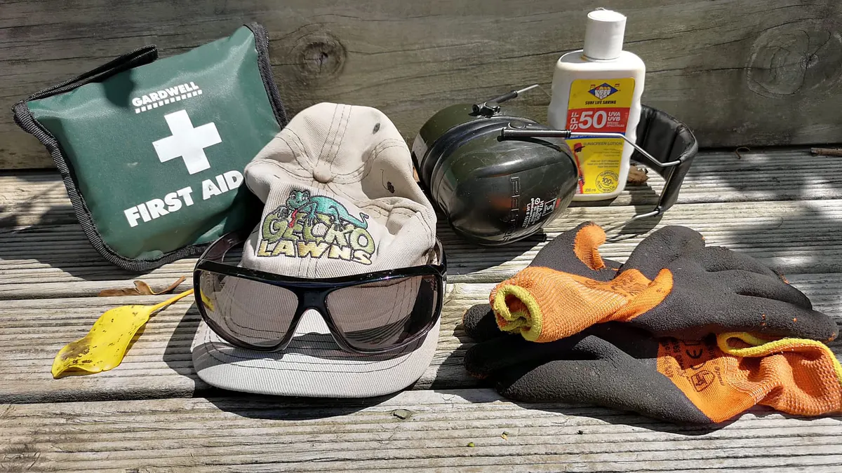 Gecko Lawns cap, safety glasses, earmuffs, gloves, sunscreen and first aid kit