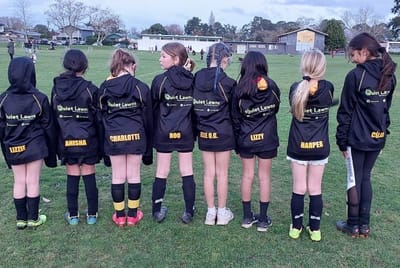 Kids' sports team wearing Quiet Lawns sponsored hoodies