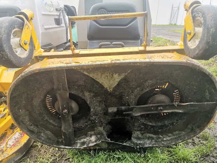 The underneath of a walker mower showing how the blades overlap. 