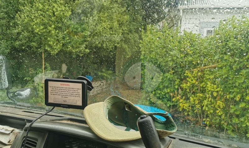 Driving a lawn care vehicle on a rainy day.