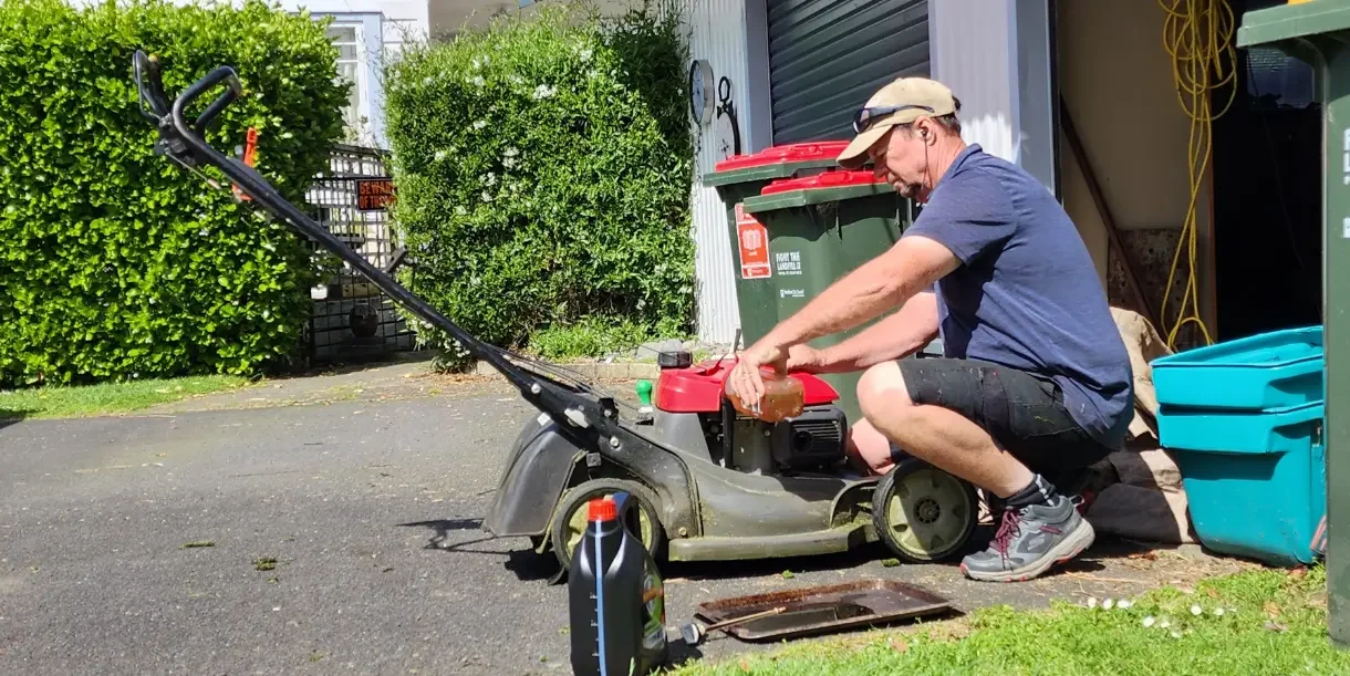 Changing oil on a lawn mower