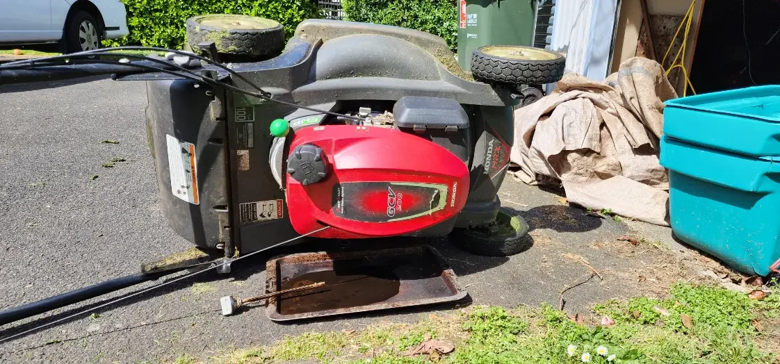 Doing an oil change on a lawn mower
