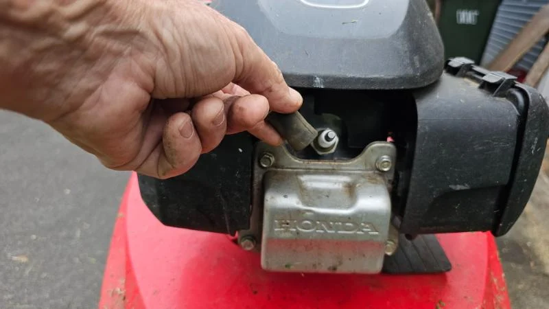 Lawn Mower Spark Plug being removed