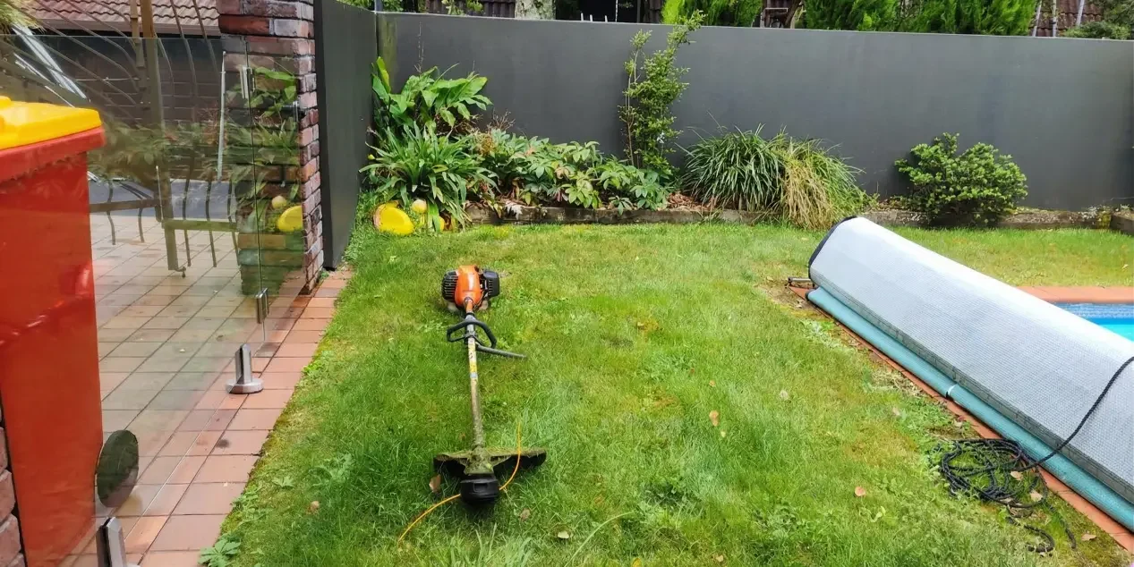A weed eater on a nice lawn