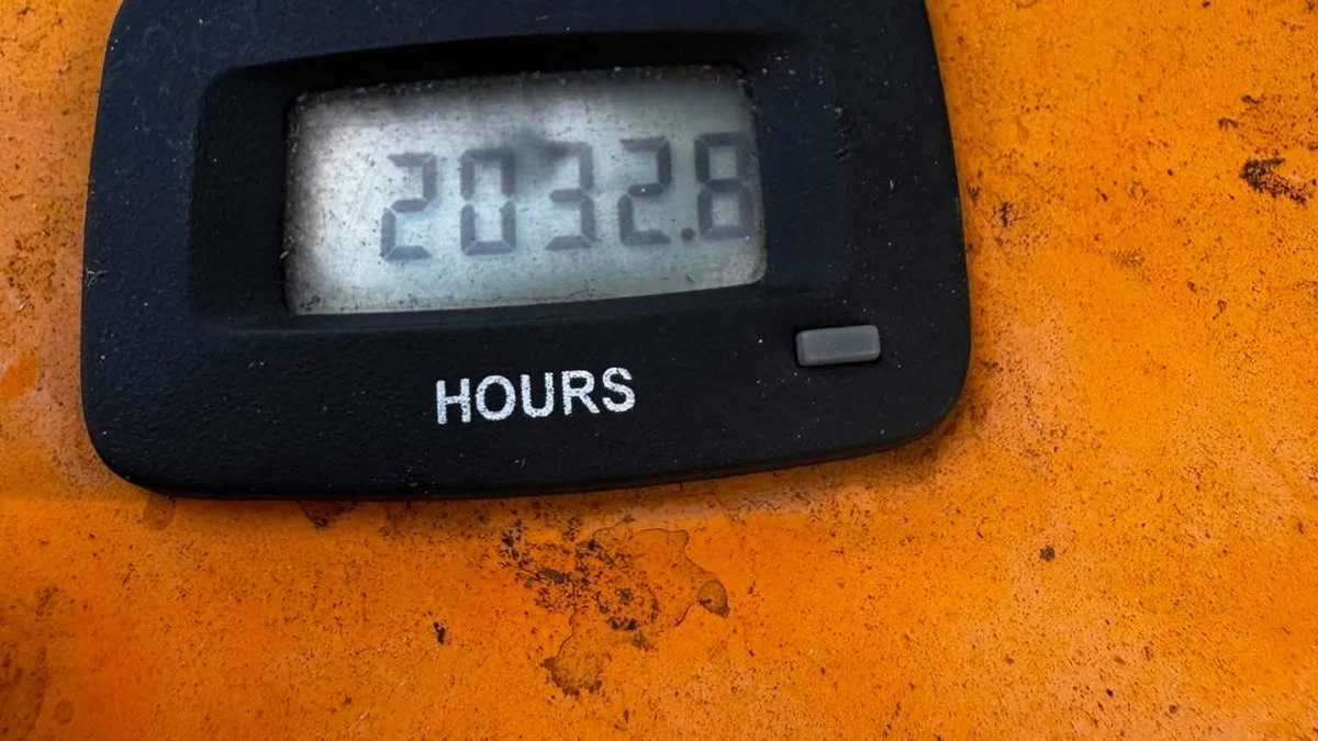 Hour meter on a commercial mower showing 2032 hours